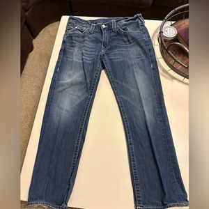 True religion jeans. Some fraying in the material at the heels of both legs.